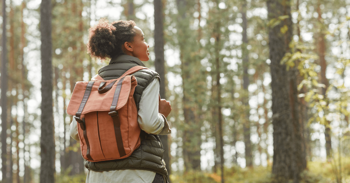 Young Woman with Backpack Outdoors - stock photo/Getty Images