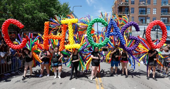 Participants carry balloons spelling out "Chicago" during the 51st LGBTQ Pride Parade in Chicago, Illinois