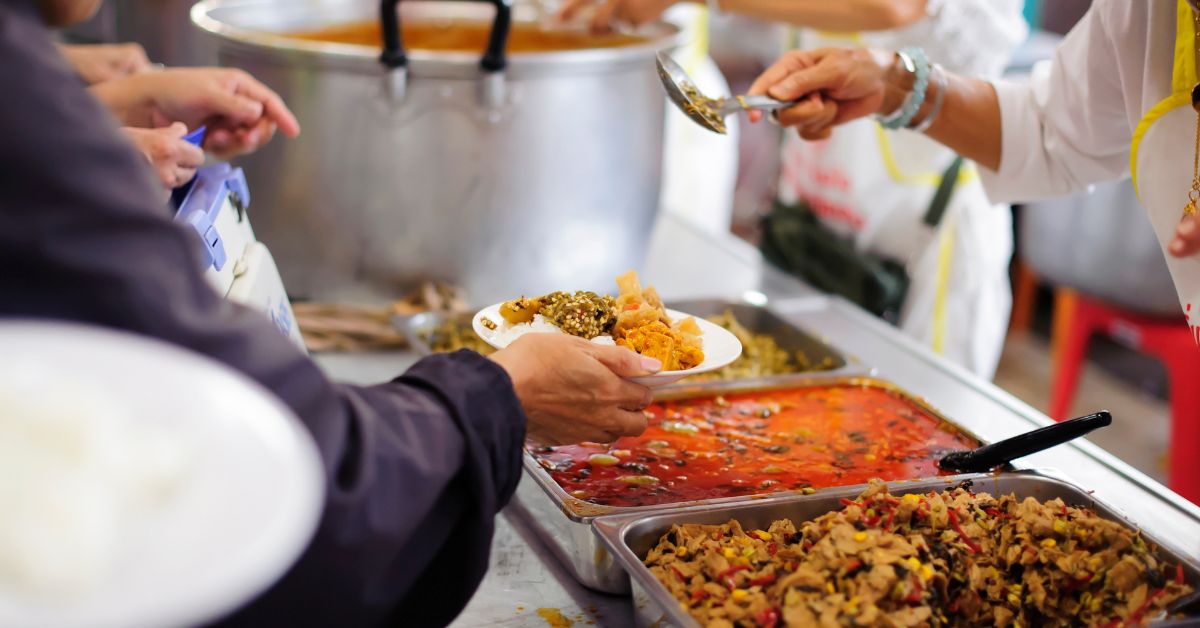 Trays of food being served at a homeless shelter