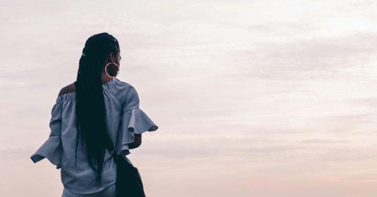 Black girl stares out toward nature 