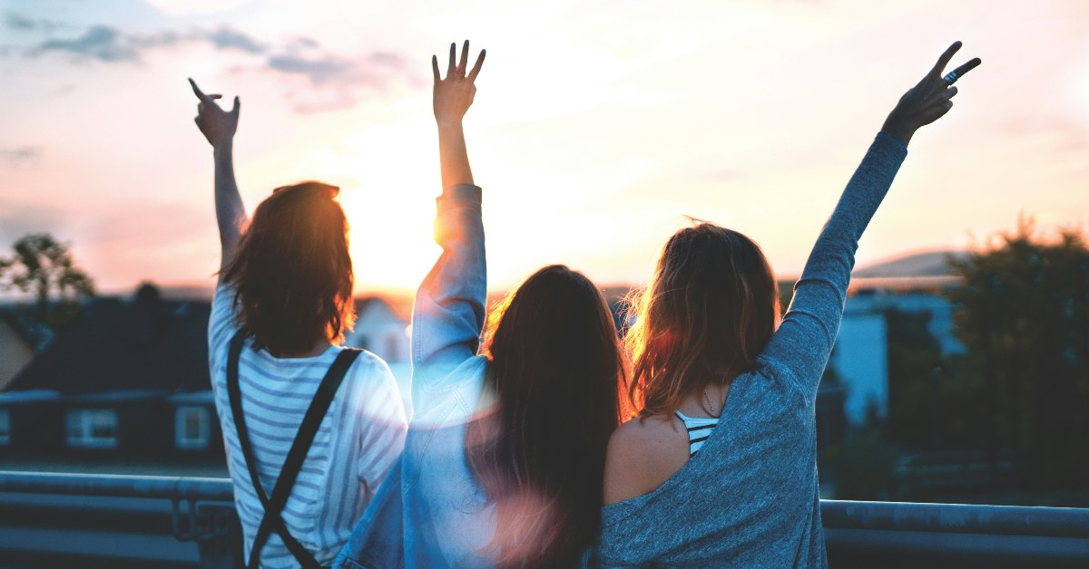 Teenagers raising their hands